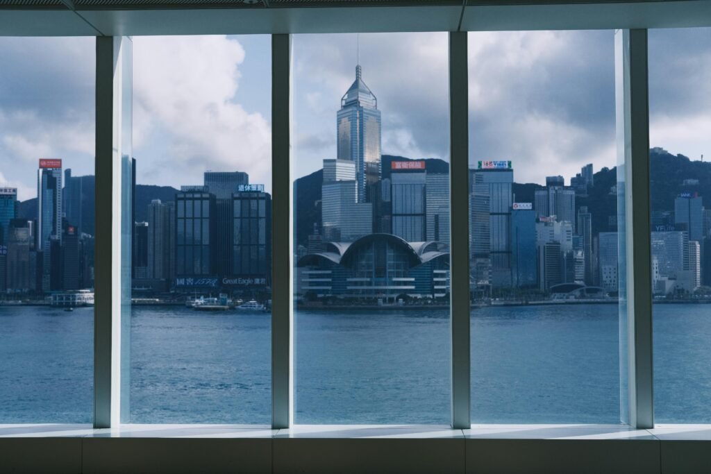 Captivating view of Hong Kong's skyline and waterfront from a modern interior.